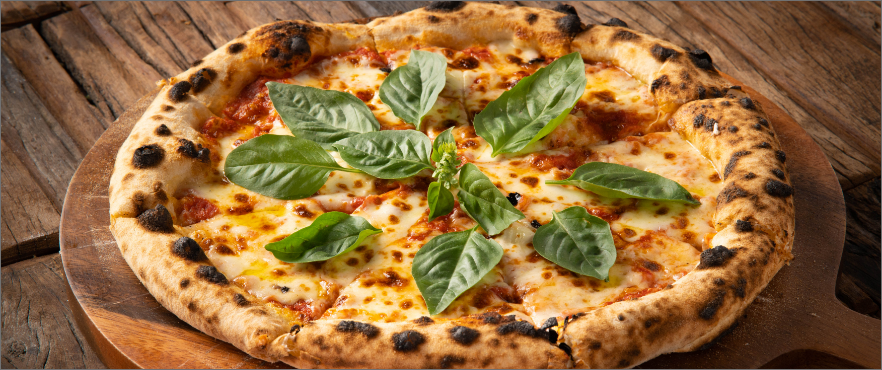 A wood-fired pizza with imported cheeses, basil and olive oil
