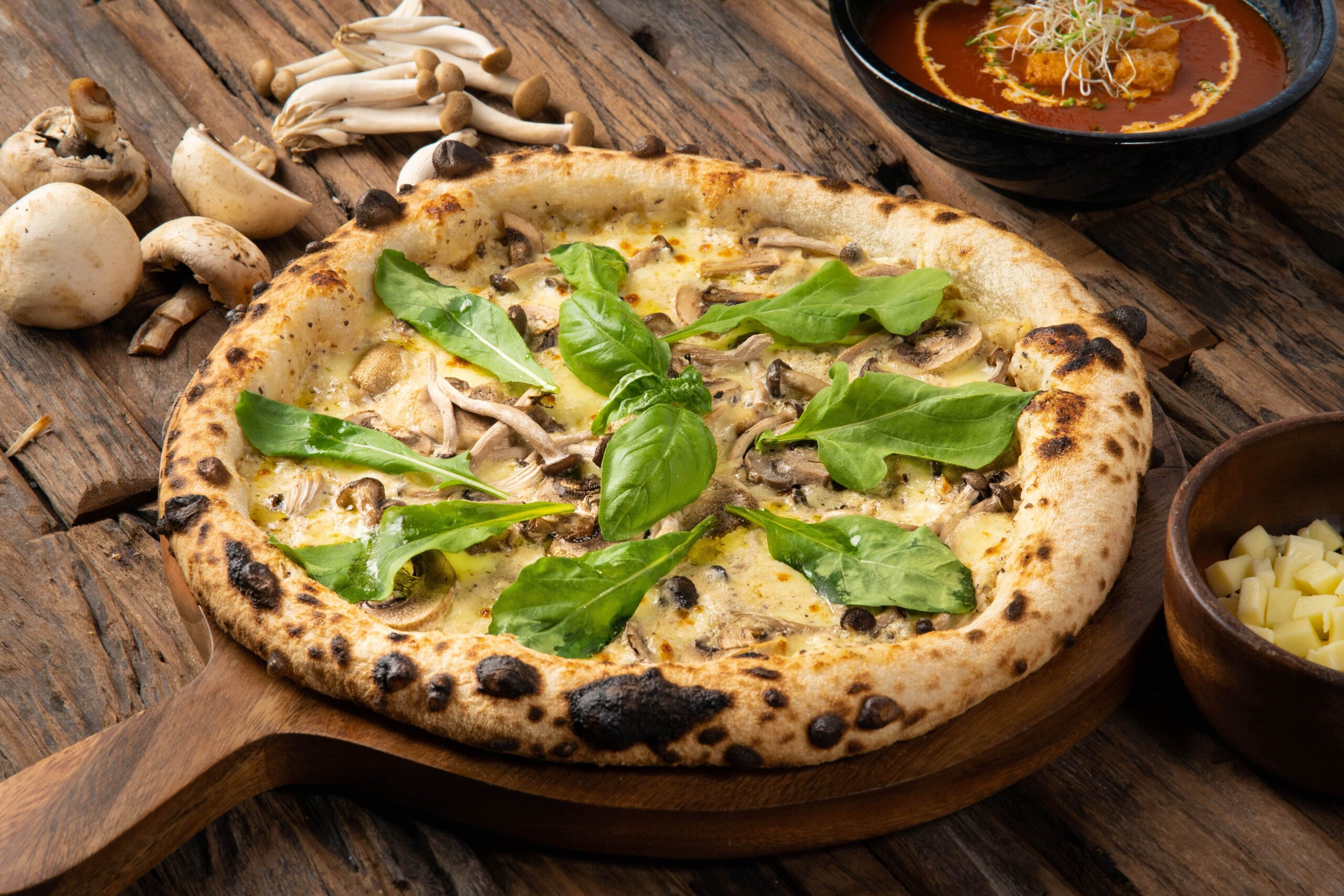 A wood-fired pizza with truffle mushroom cream & oil, mushrooms and imported cheeses